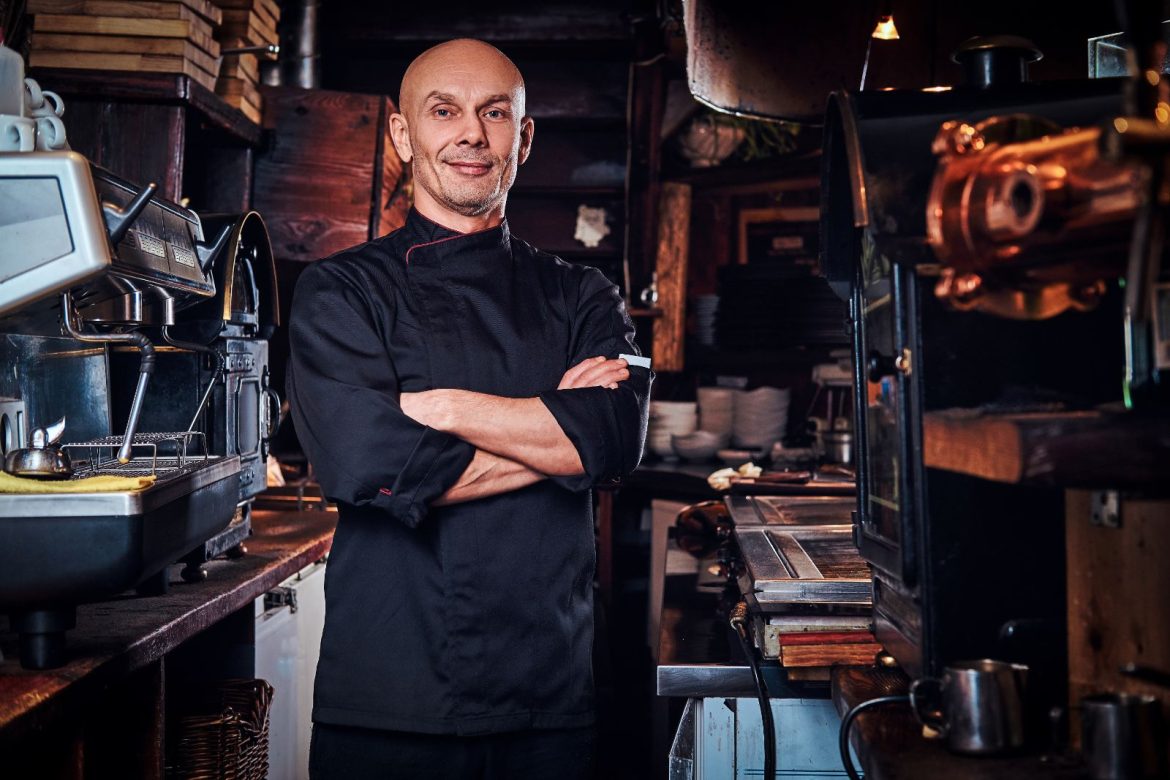 A chef standing in the kitchen of an independent restaurant